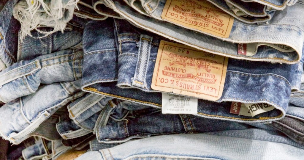 pile of levi's jeans folded on top of one another
