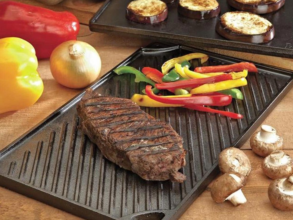 steaks and peppers on grill/griddle on counter