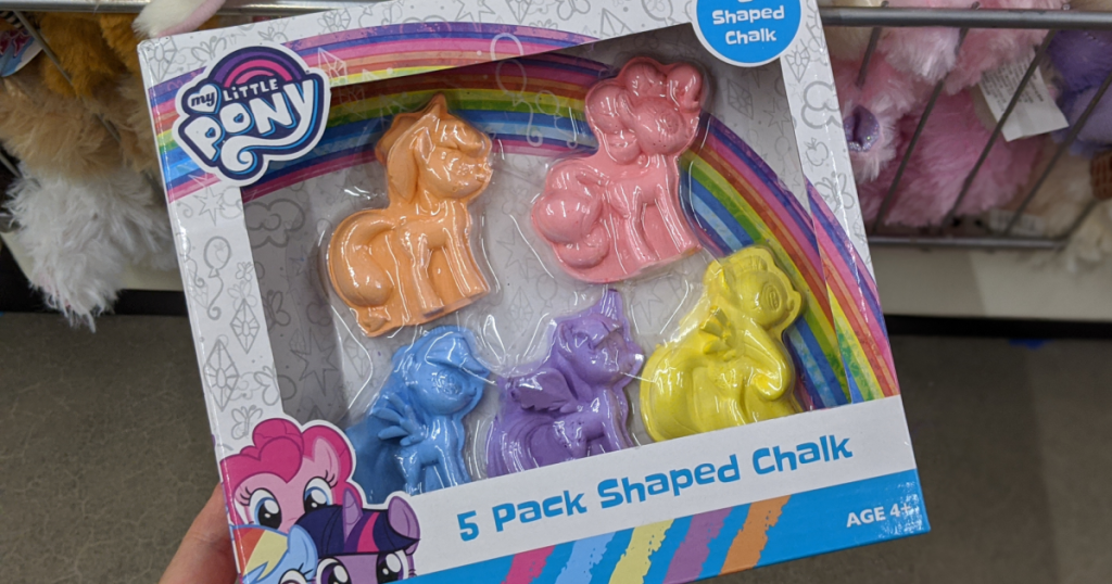 hand holding box of sidewalk chalk in the shape of ponies