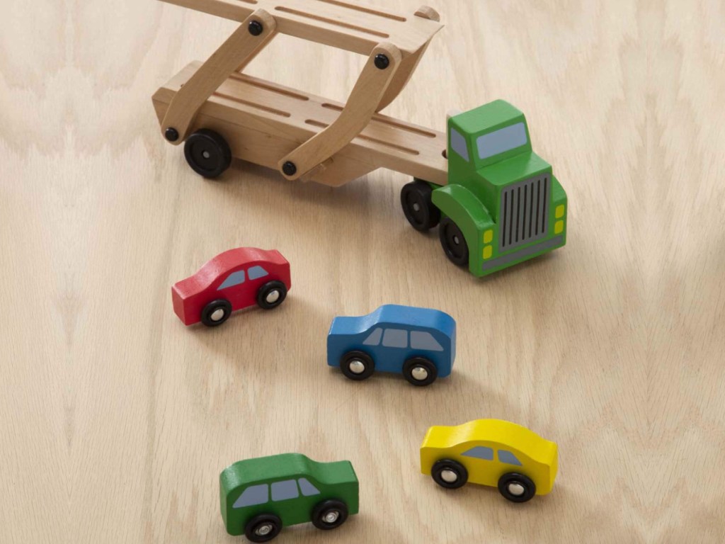 Melissa & Doug Car Carrier Wooden Toy Set on a wooden floor