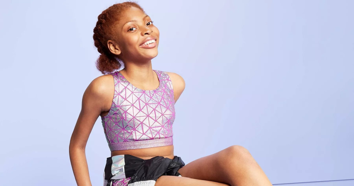 little girl wearing purple and silver more than magic sports bra