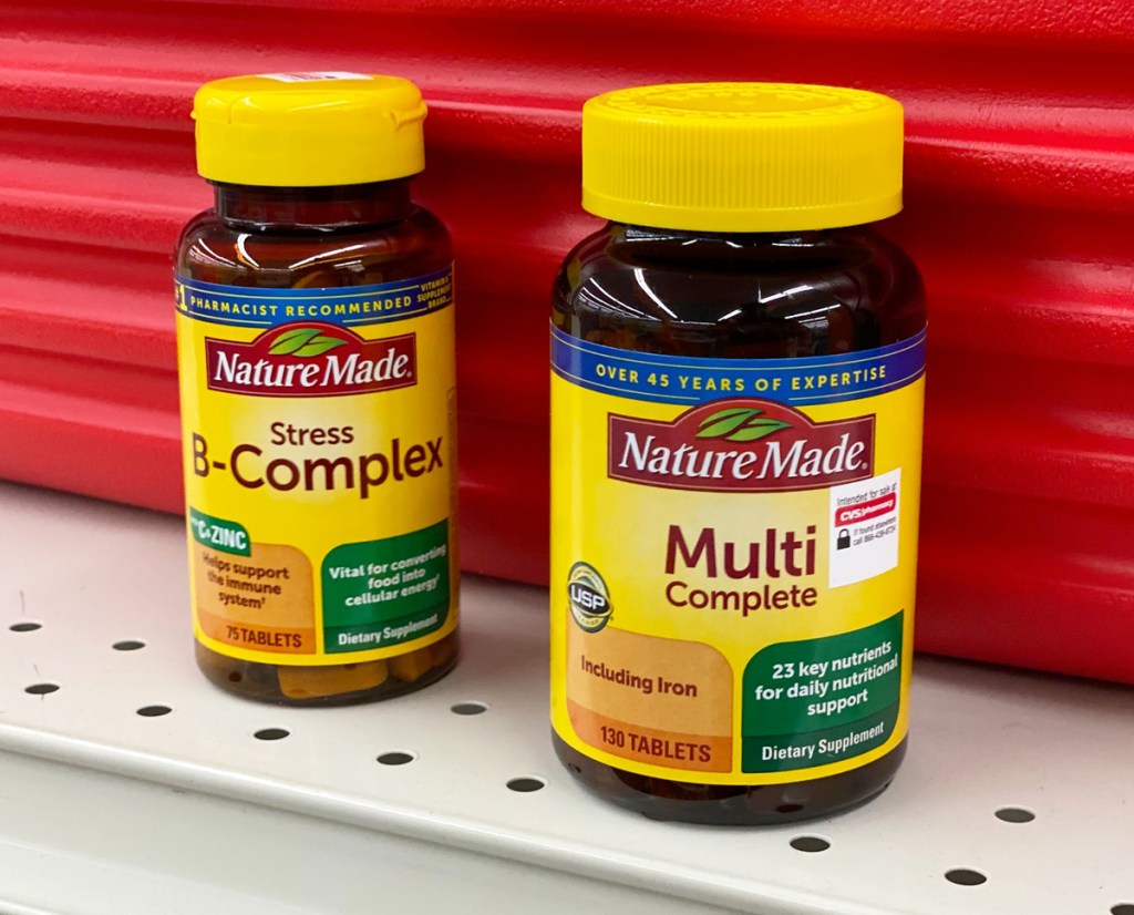 brown and yellow bottles of Nature Made B-Complex and Multi Complete Vitamins on CVS store shelf