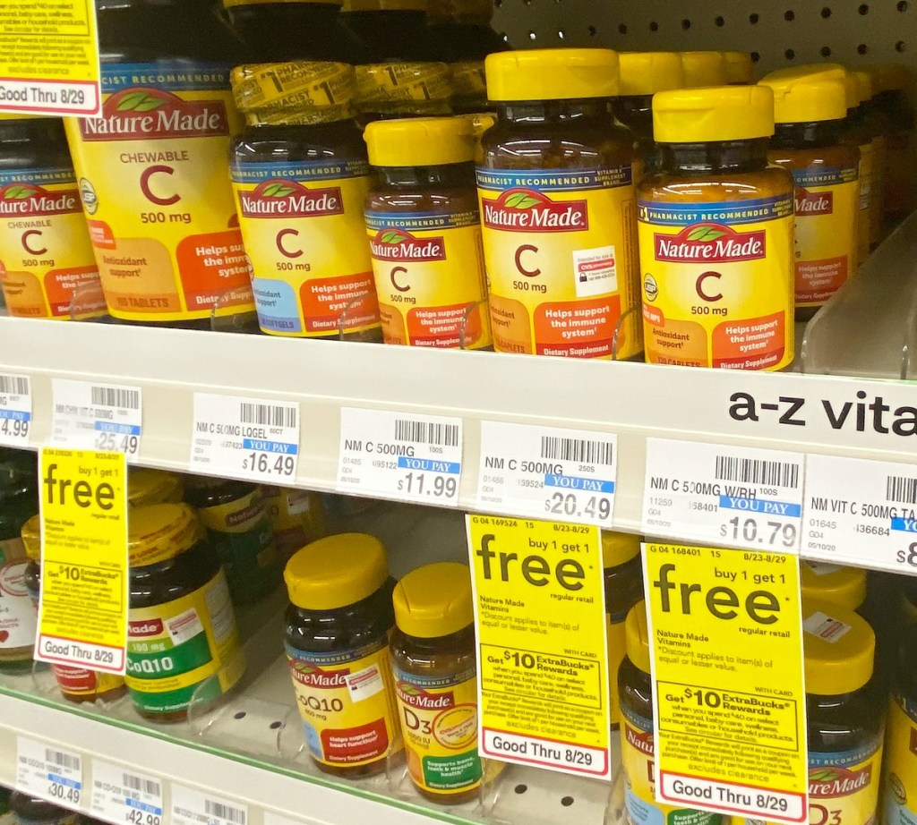 yellow and brown bottles of Nature Made vitamins on CVS store shelf with yellow sale tags