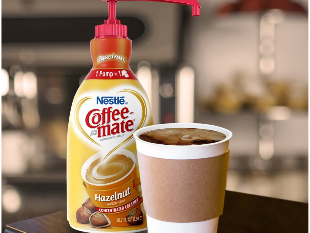 large bottle of hazelnut coffee creamer and cup of coffee