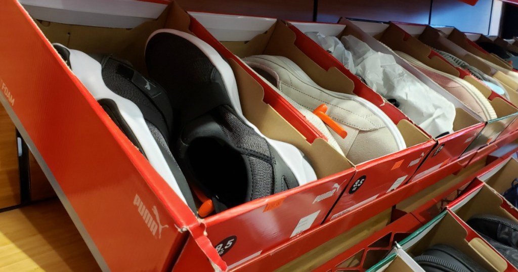 row of PUMA shoes in boxes