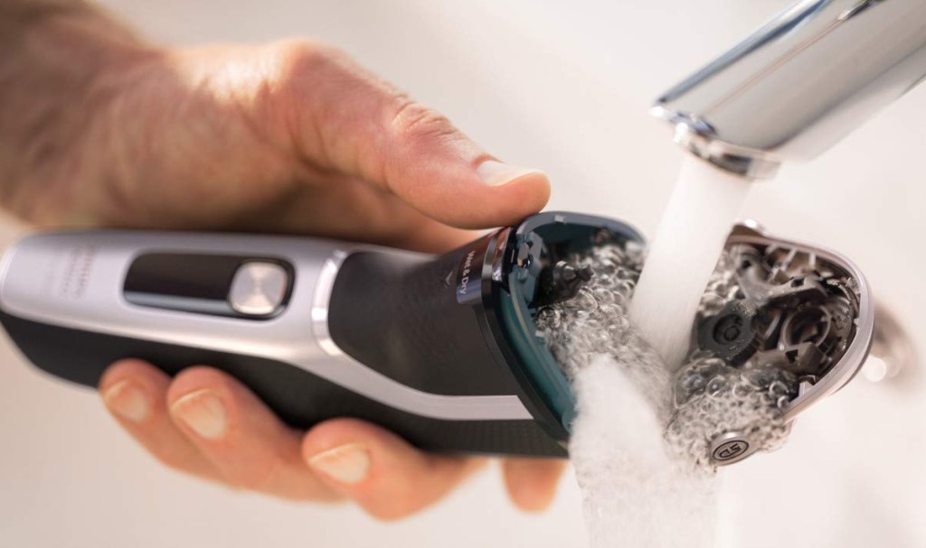 Philips Norelco Shaver 3800 being washed in sink