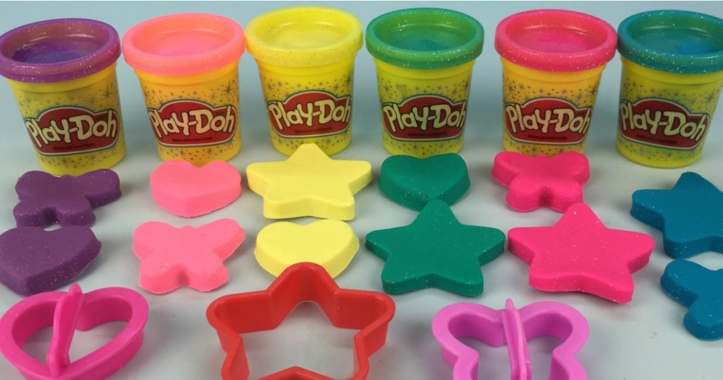 6 tubs of glitter play-doh, cut out play-doh, and three cutters