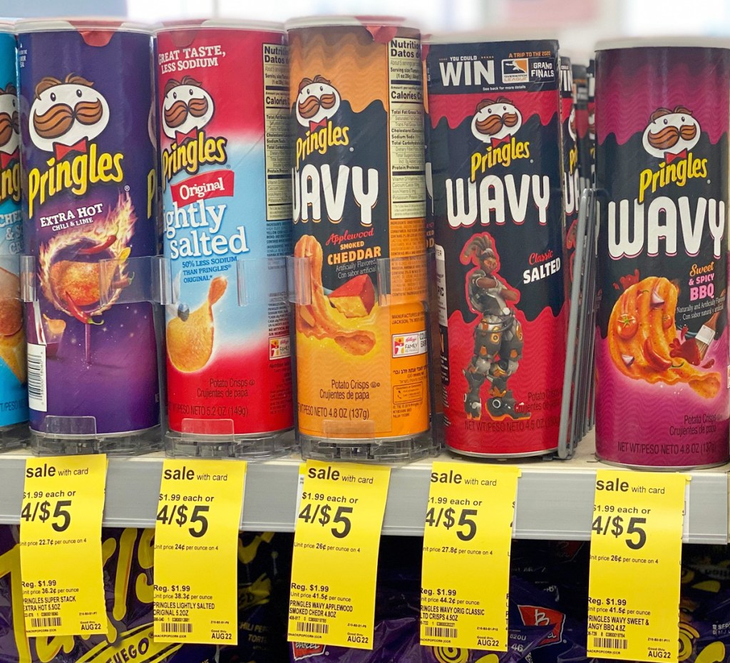 cans of Pringles Chips in various flavors on Walgreens store shelf with yellow sale tags