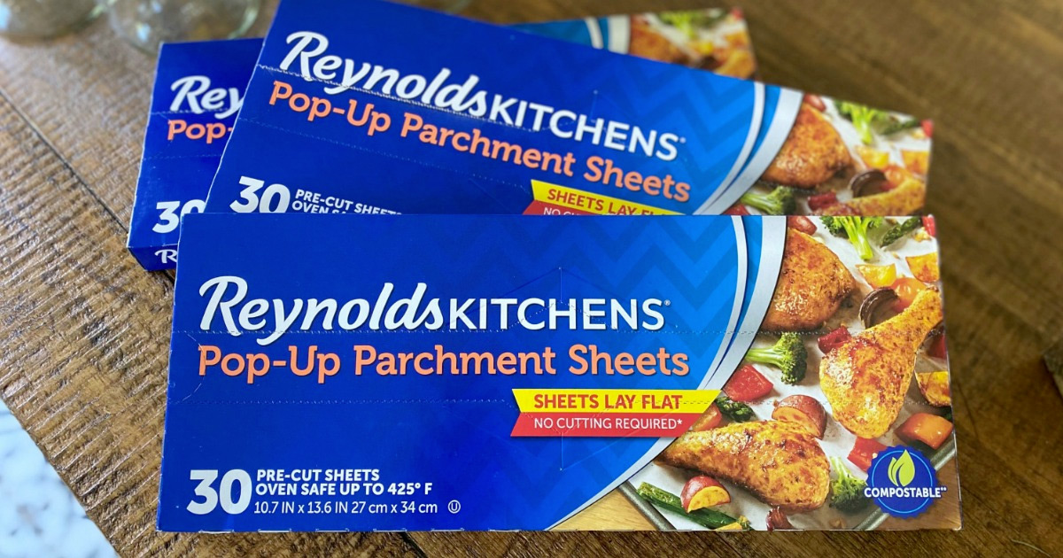 three blue boxes of reynolds parchment paper sheets on wood table