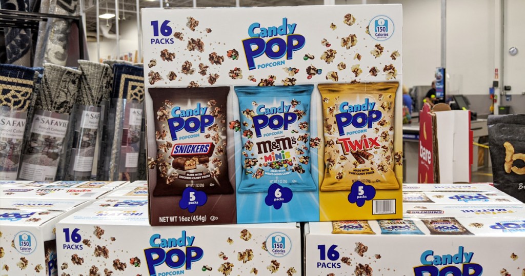 box of candy pop popcorn in snickers, m&ms, and twix flavors