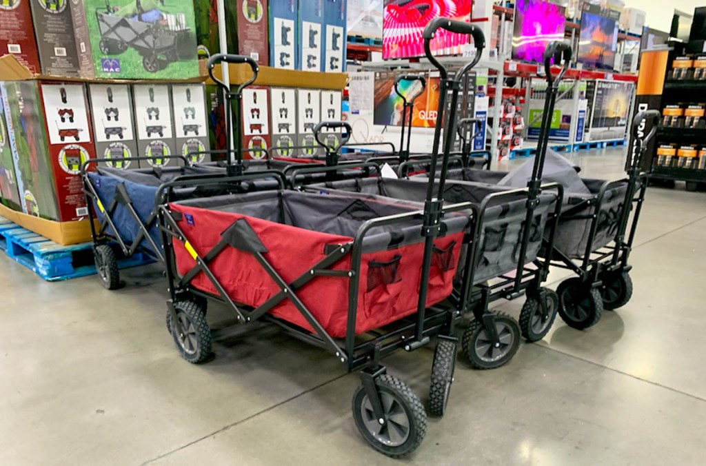 red, blue, and grey colored folding wagons parked on display at Sam's Club