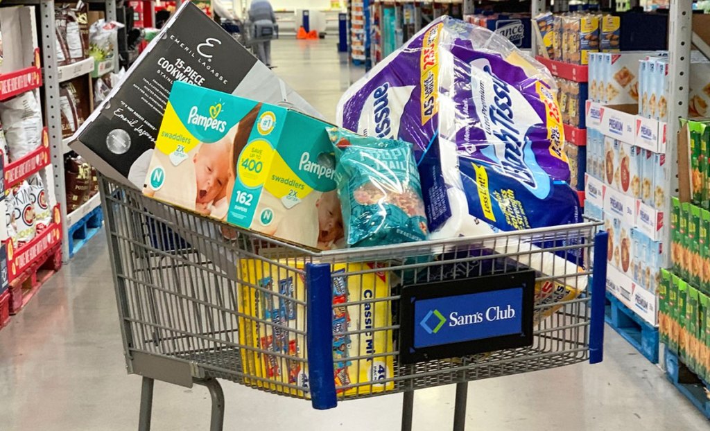 Sams Club shopping cart full of paper products and snacks