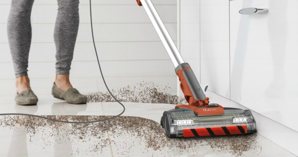 person vacuuming up dirt