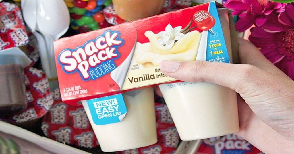 person holding up a 4 pack of Snack Pack vanilla pudding cups