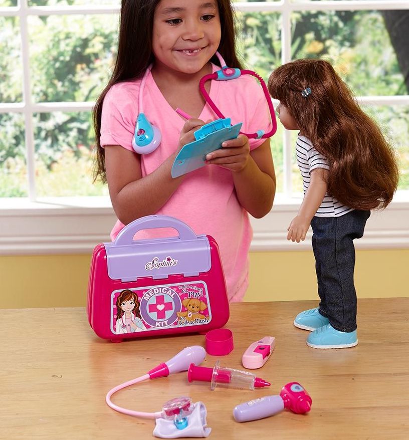girl playing doctor with her doll