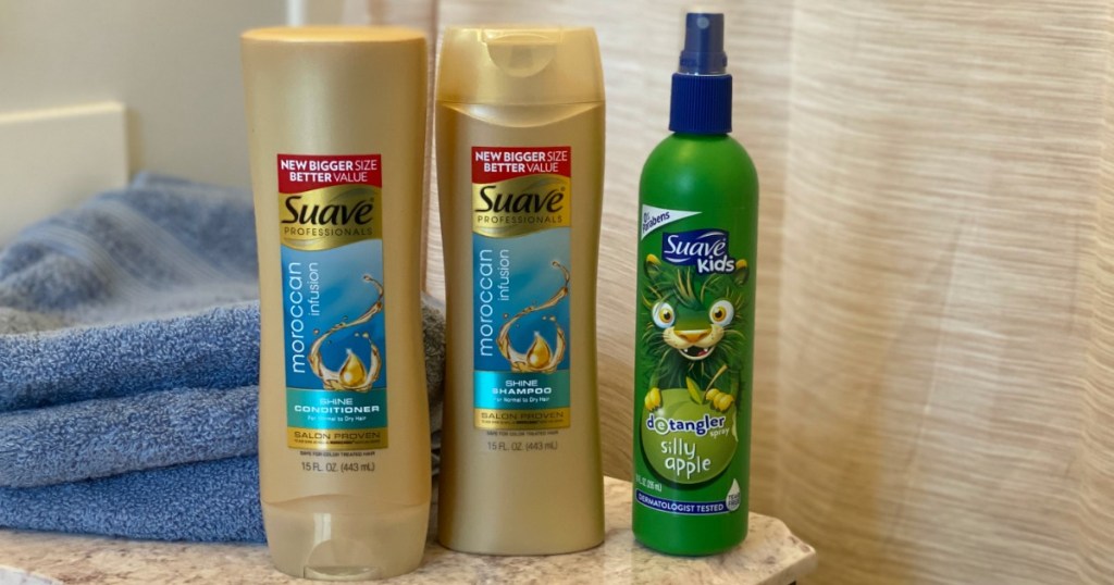 Suave Shampoo, Conditioner and Detangler next to stack of towels