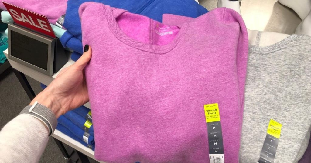 hand holding a pink women's sweatshirt