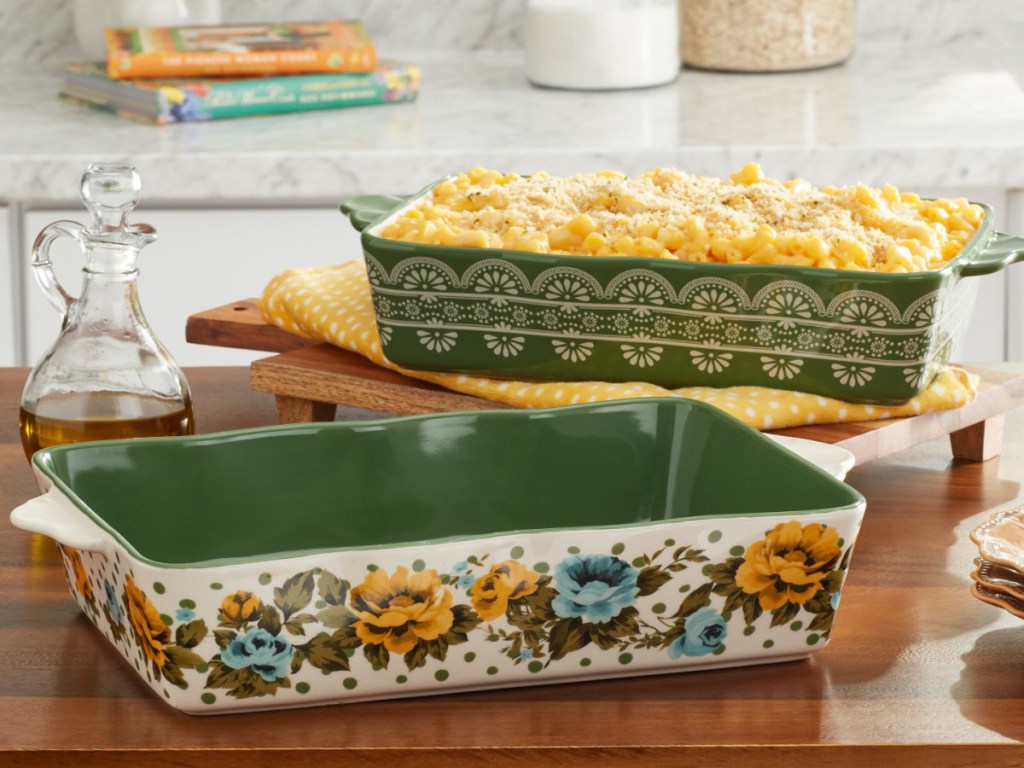 two baking dishes on kitchen counter, one with cooked food