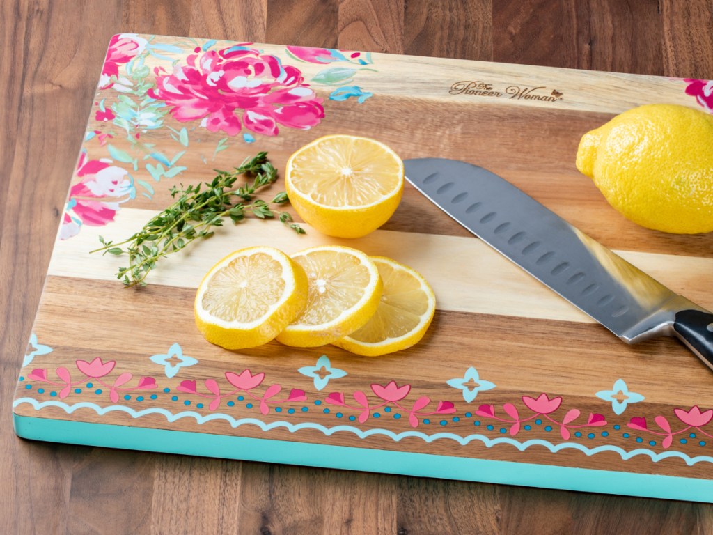 floral design wood cutting board, knife, lemon and lemon slices