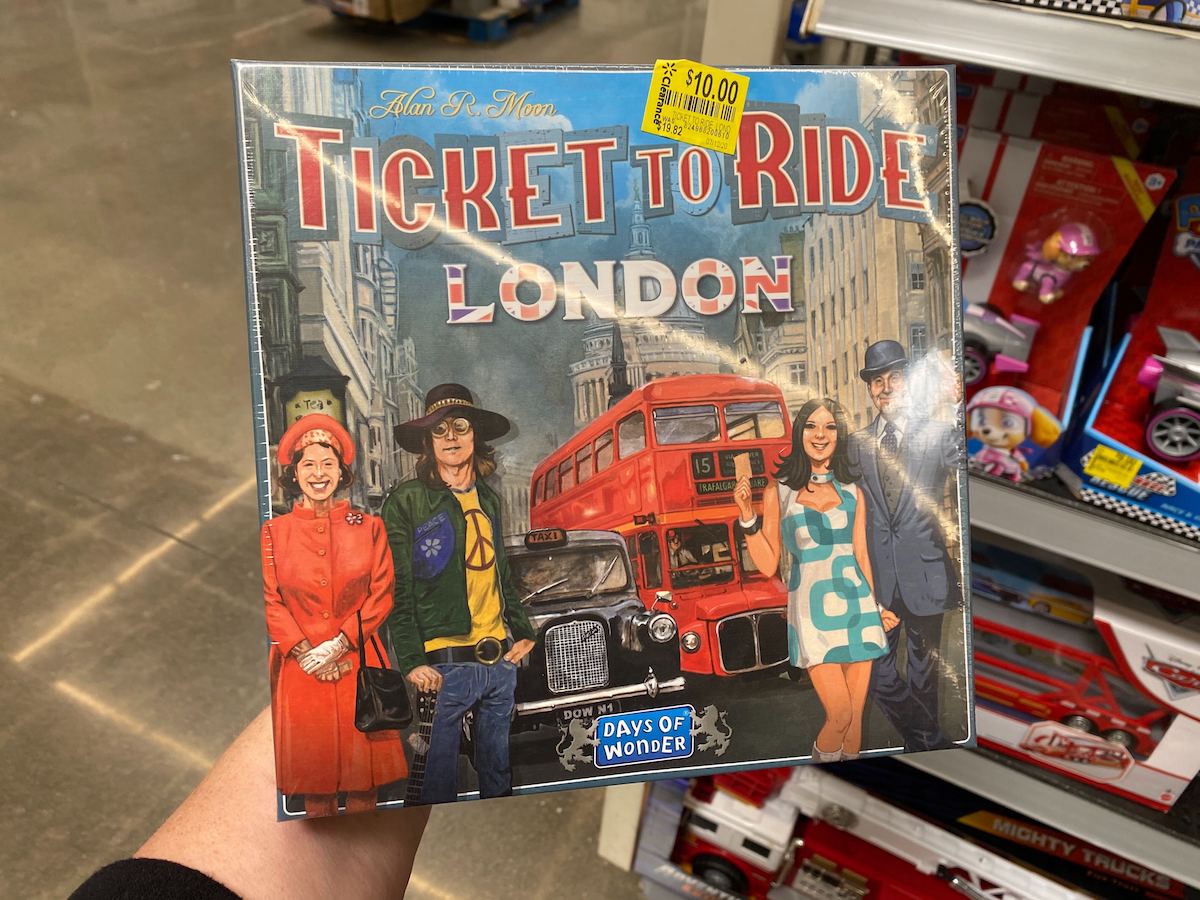 hand holding Ticket to Ride London board game box in store