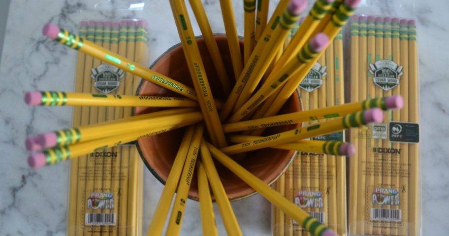 pencils in cup and packages of pencils on table
