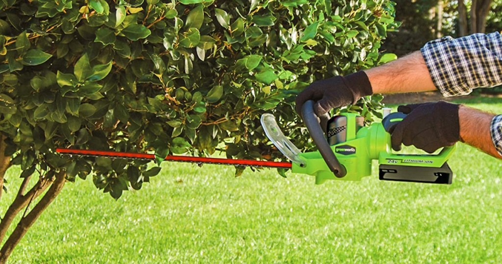 Greenworks hedge trimmer with man hands holding