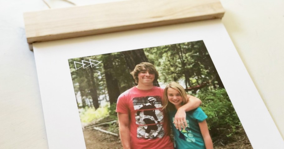 photo of brother with arm around sister on a wood hanger board print