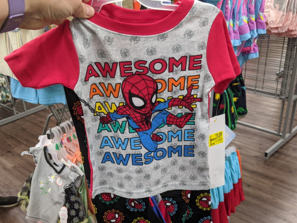hand holding spiderman pajamas in-store