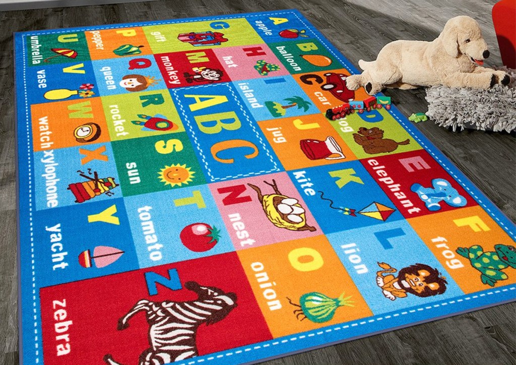 colorful kids alphabet area rug on hardwood floor with plush stuffed dog
