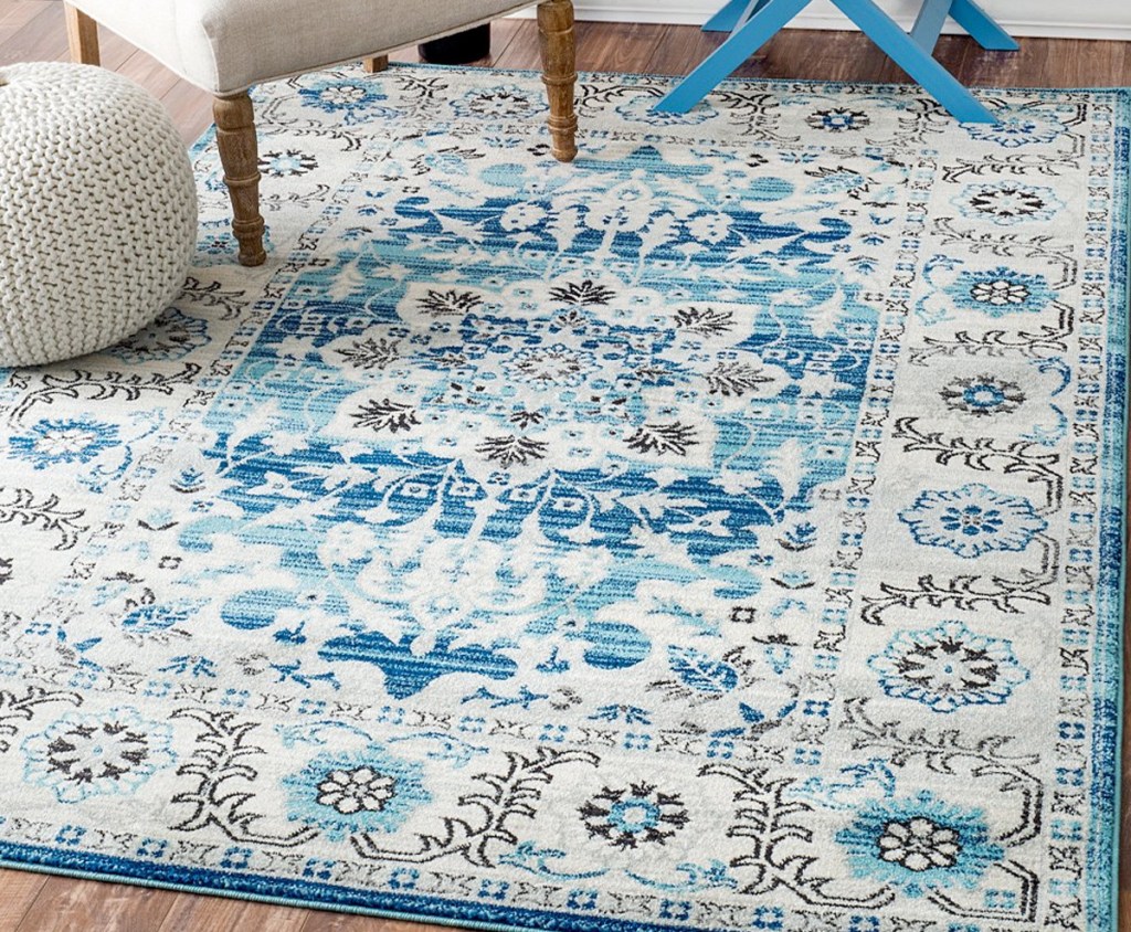 cream and blue oriental rug on hardwood floor