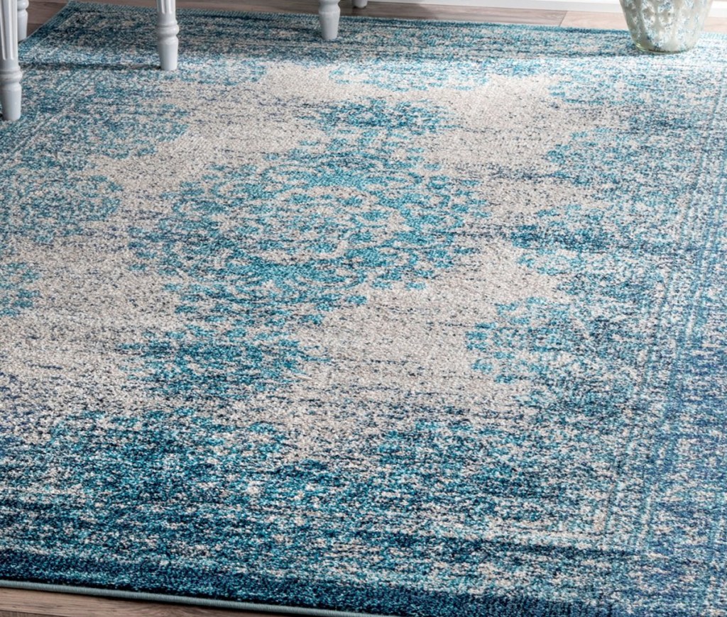 blue and cream medallion area rug on hardwood floor