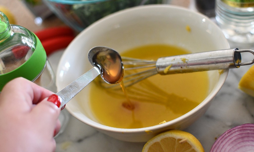 adding honey to salad dressing