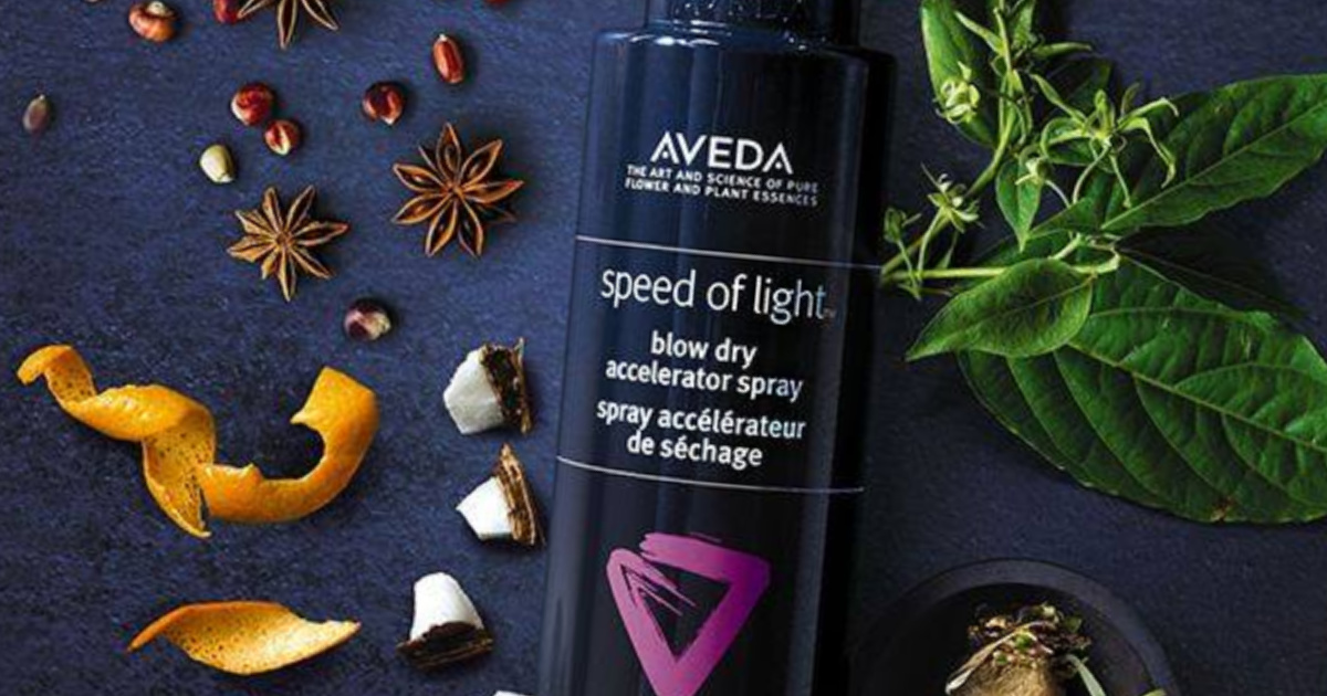 Aveda speed of light blow dry spray with flowers in background