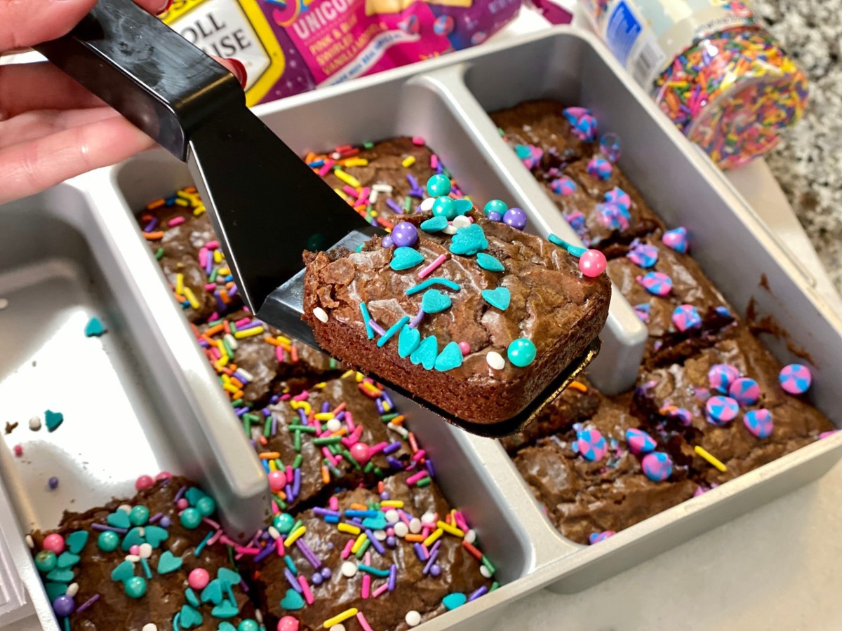 spatula holding brownie topped with blue hearts