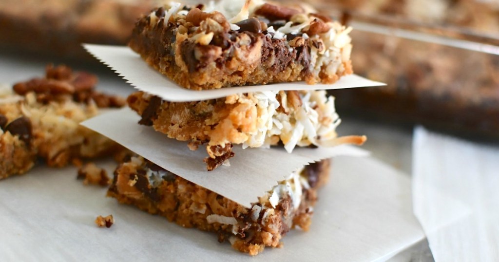 chocolate coconut magic cookie bars stacked up 