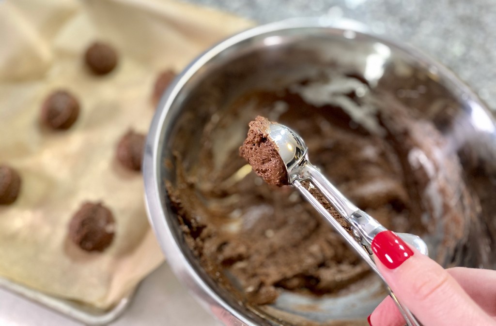 using cookie scoop to portion cookie dough