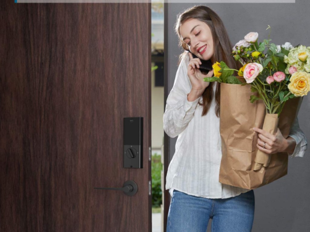 teen girl with brown paper bag with flowers and door open with eufy smart lock