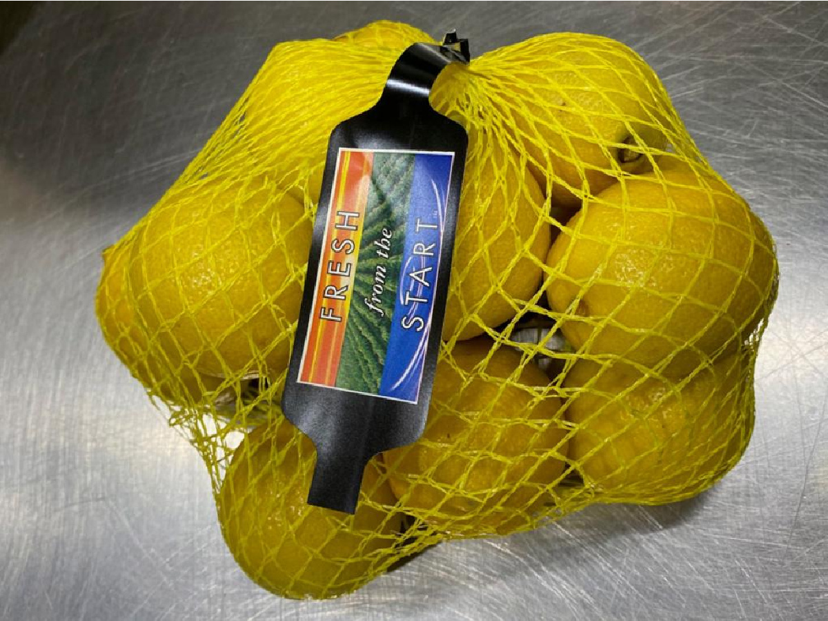 mesh bag of lemons with brand tag
