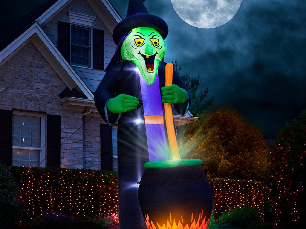 giant witch and cauldron decoration inflatable in front yard
