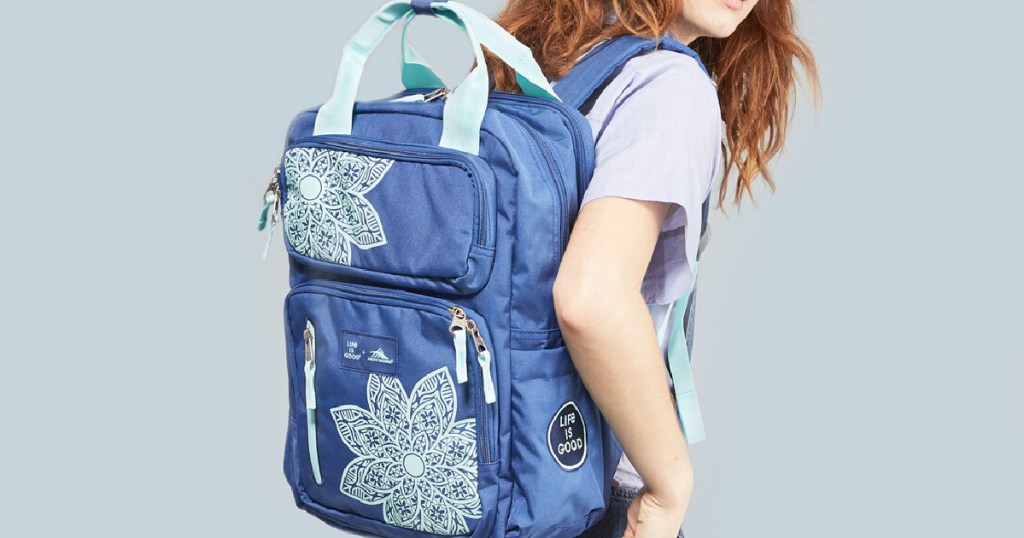 girl wearing a blue flowered backpack