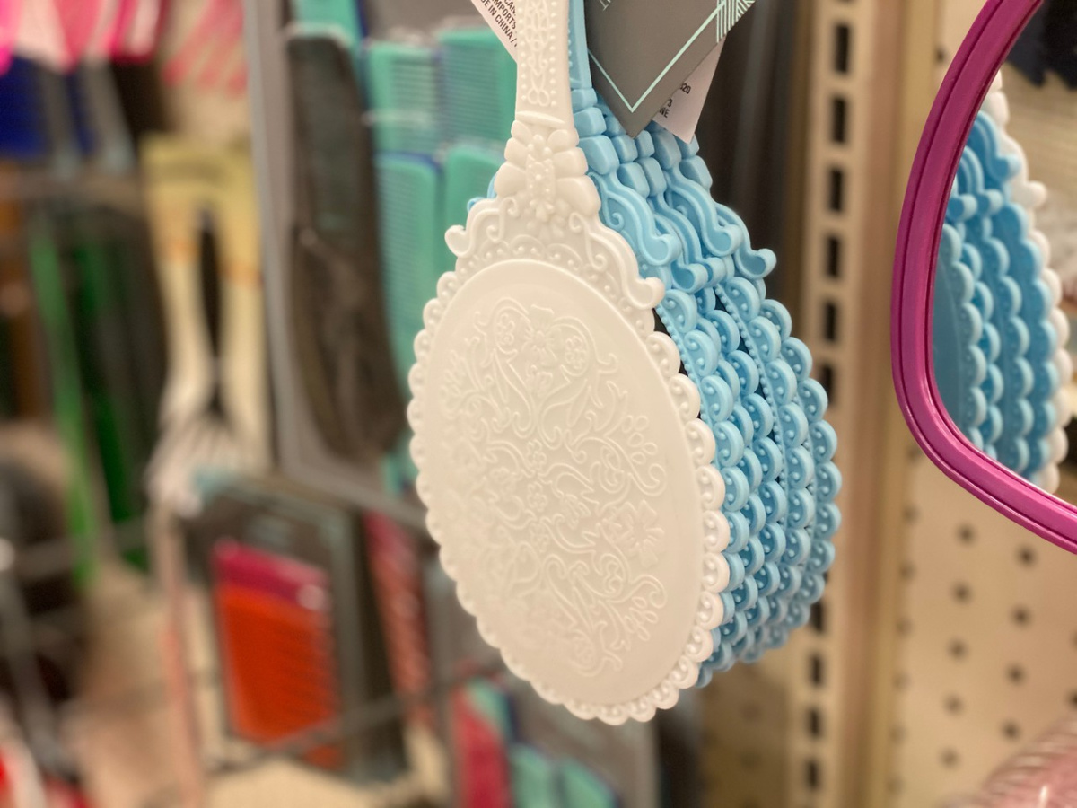 store shelf with mirrors hanging on pegboard