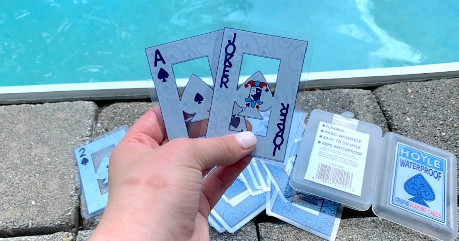 Hoyle Waterproof Playing Cards being held by hand next to pool