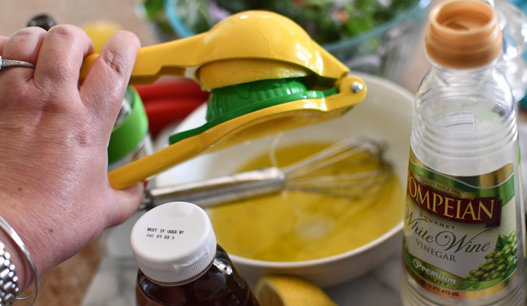 using citrus lemon juicer to squeeze lemon for juice