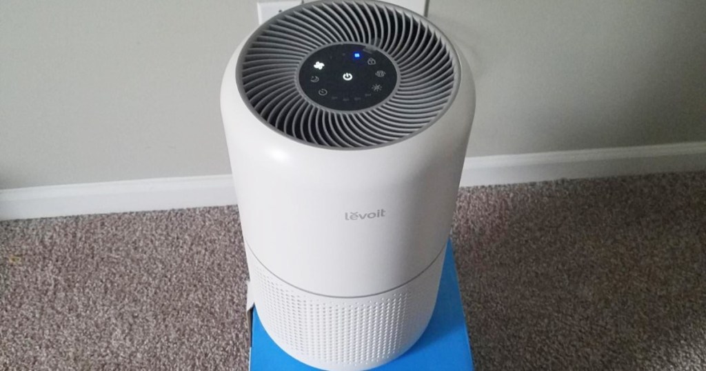 white air purifier sitting on blue box