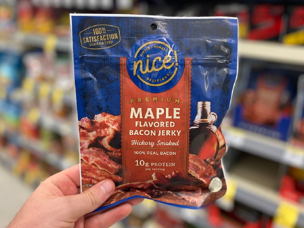 hand holding package of jerky in a store