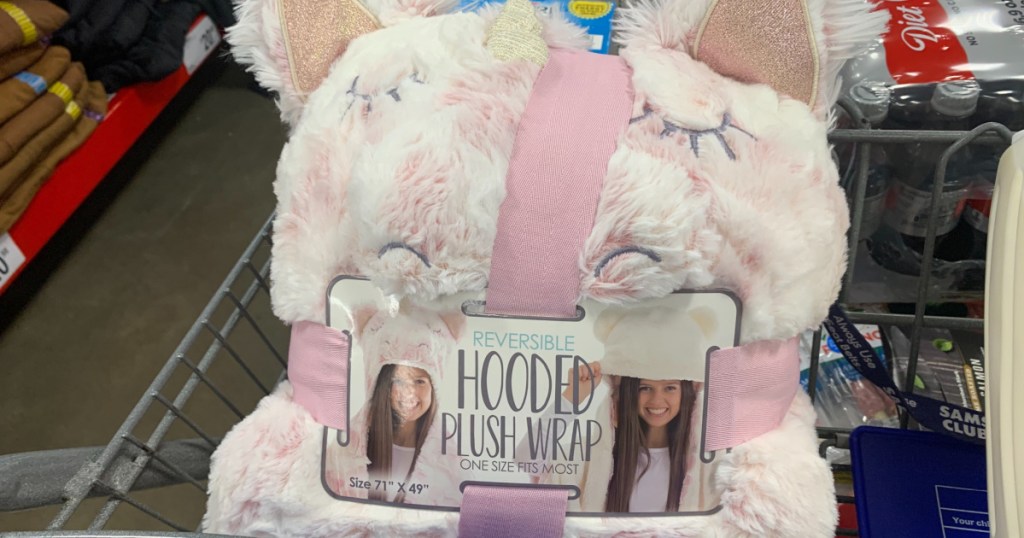 pink and white unicorn hooded blanket in grocery cart in store