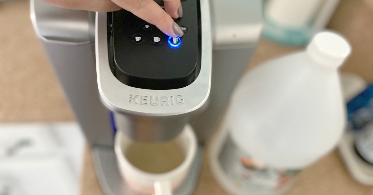 pressing a button on the Keurig