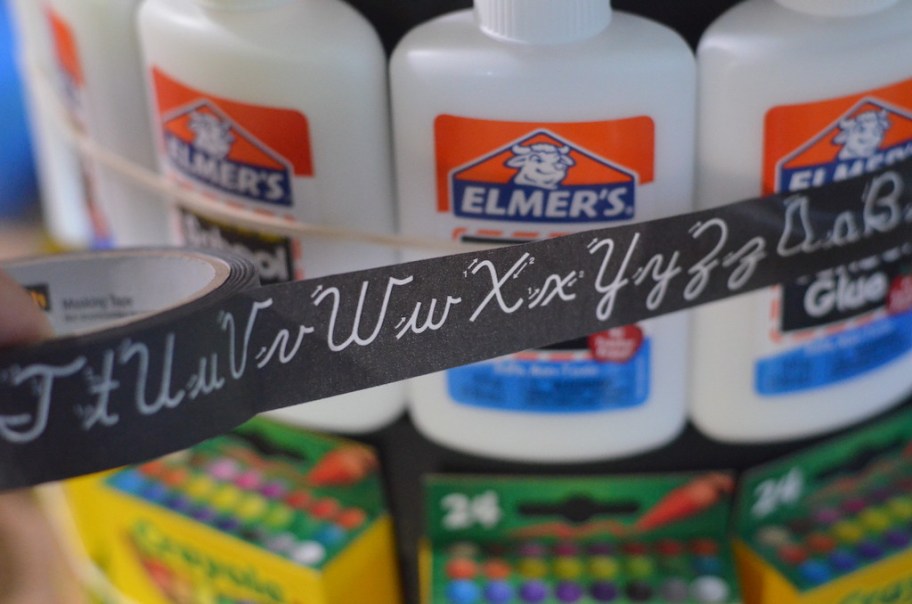 putting ribbon around Elmer's glue bottles 