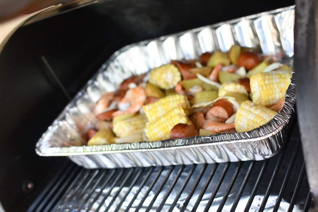 pan of shrimp boil ingredients on the grill