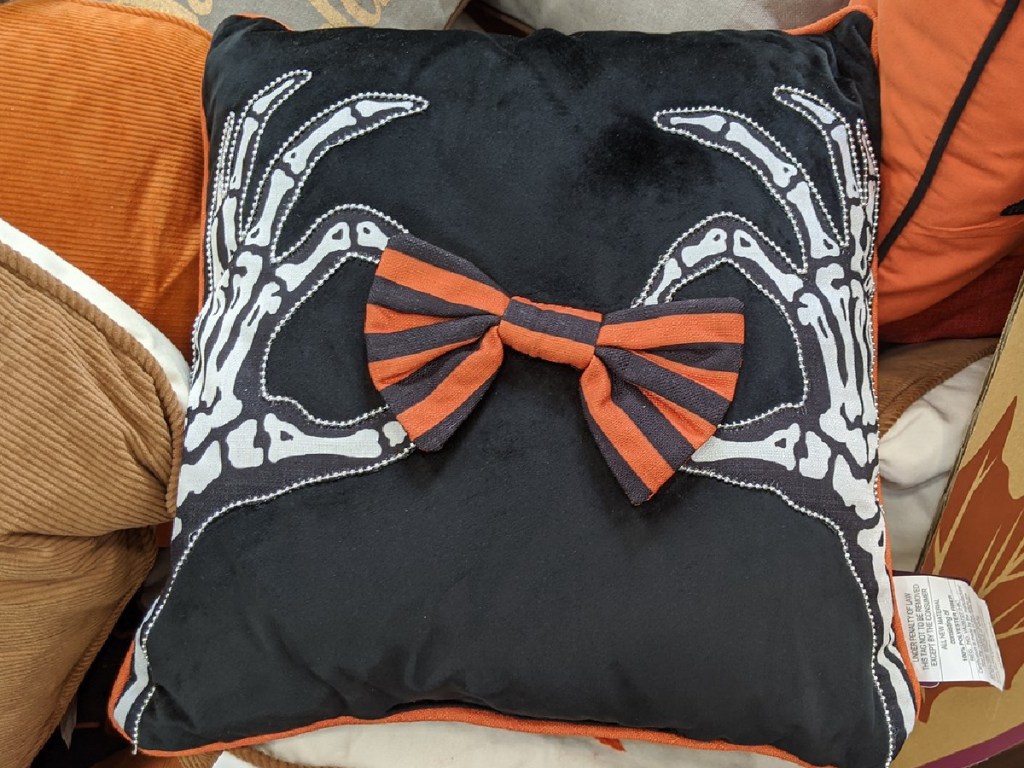 black pillow with skeleton print on it